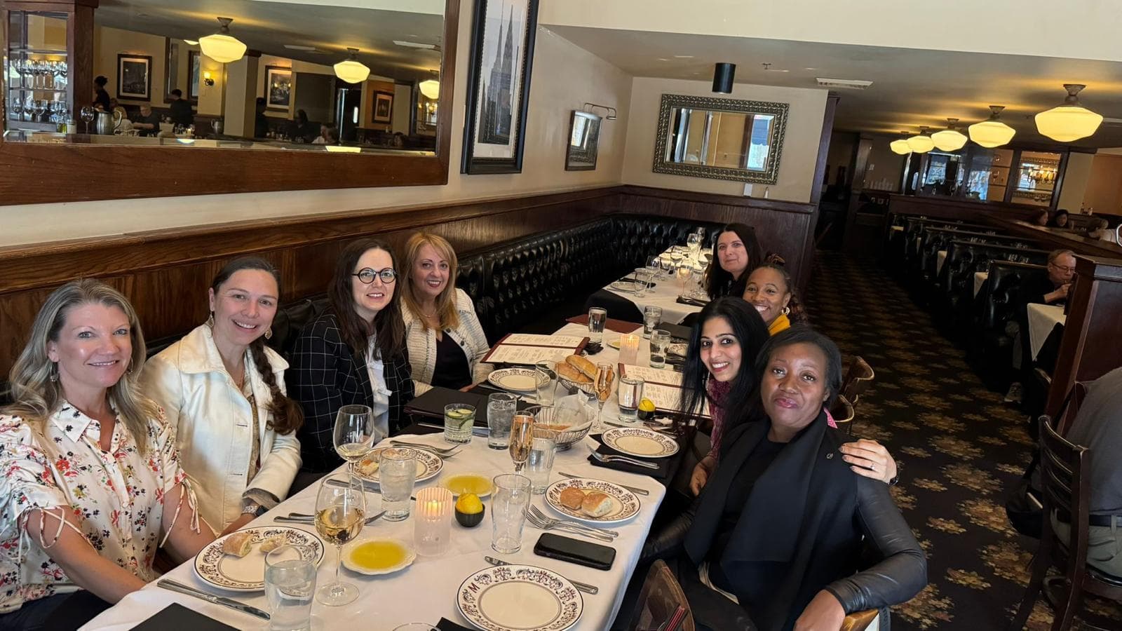 Members at a chapter dinner in a wood panelled dining room