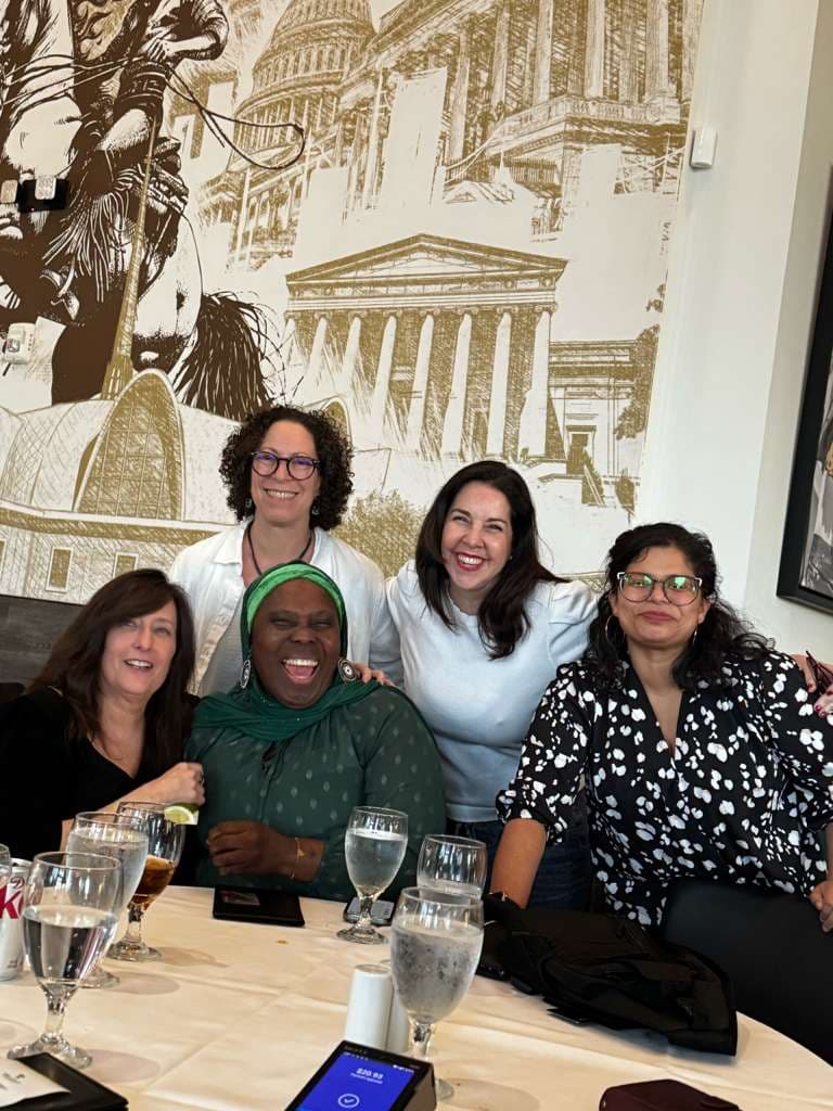 Members laughing together at a table in Washington DC