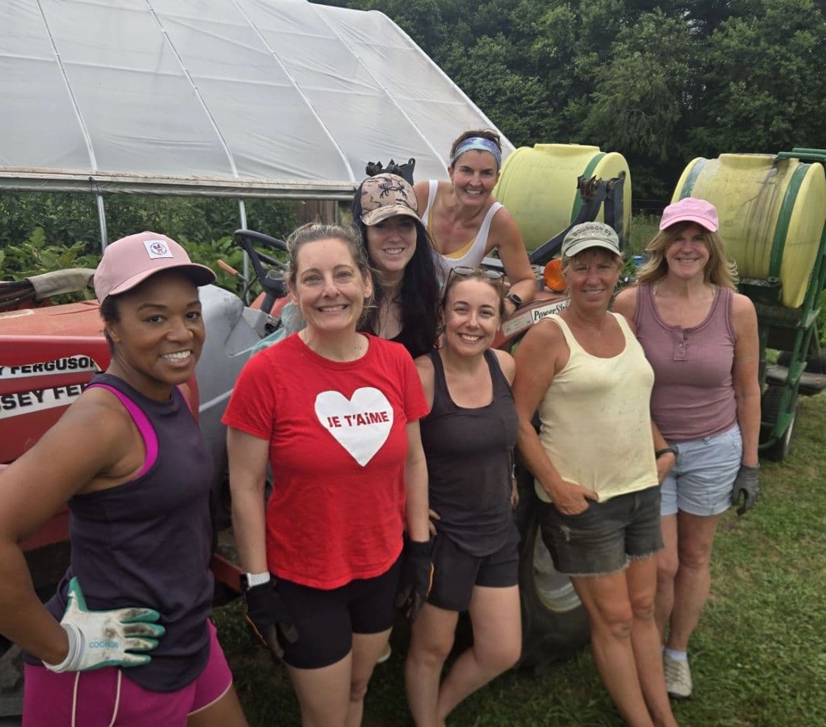 Members beside a tractor on a farm volunteer day