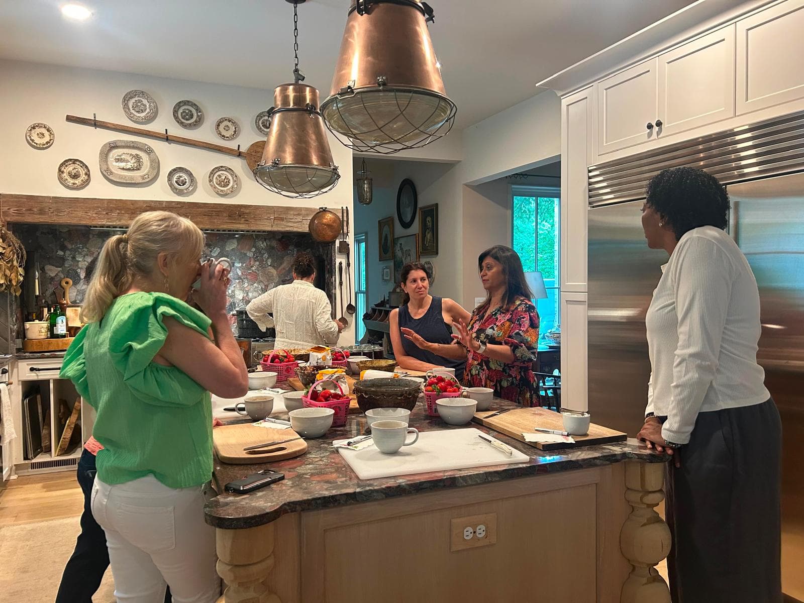Members in conversation across a kitchen island